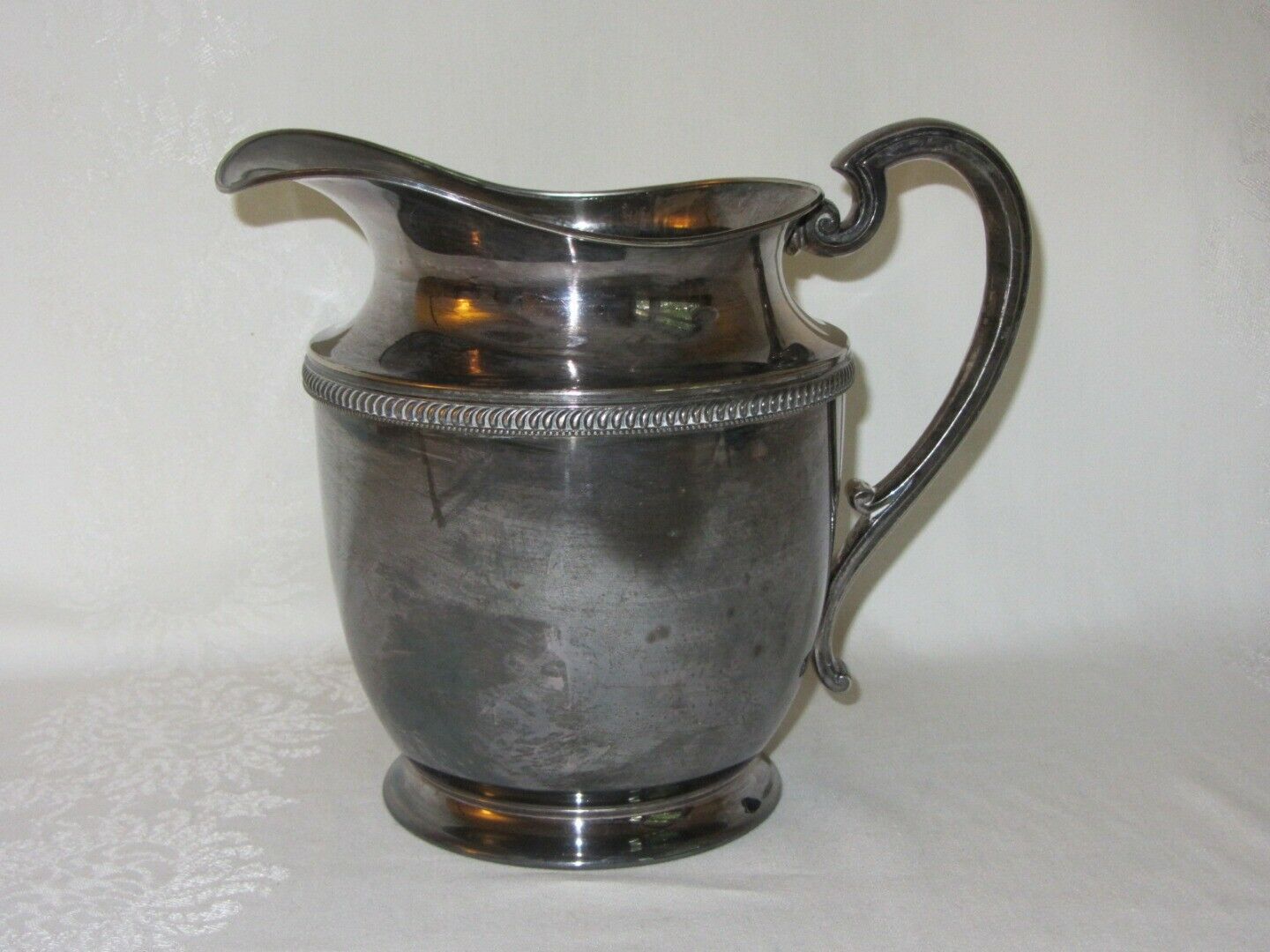 silver and silver plate: St. Louis Silver Syrup Pitcher